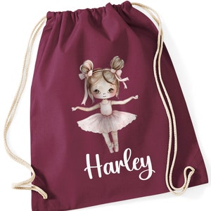 May include: Burgundy drawstring bag with a white personalised name "Harley" and a cartoon illustration of a ballerina girl with brown hair and a pink tutu.