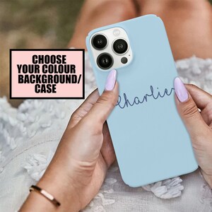 May include: A light blue phone case with the name "charlie" written in cursive on it.