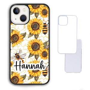 May include: A white phone case with a black border and a pattern of yellow sunflowers and bees. The name "Hannah" is written in black cursive on the case.