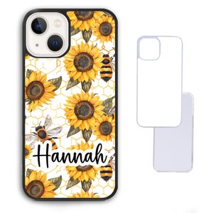 May include: A white phone case with a black border and a pattern of yellow sunflowers and bees. The name "Hannah" is written in black cursive on the case.