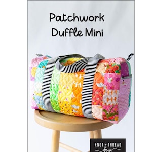 May include: A colorful patchwork duffle mini bag with a black and white striped handle. The bag is made of various fabric patterns in shades of pink, yellow, orange, and green. The text "Patchwork Duffle Mini" is at the top.