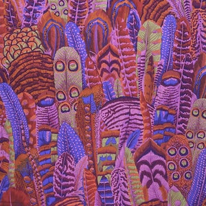 May include: A colorful fabric with a pattern of overlapping feathers in shades of purple, pink, orange, and brown.