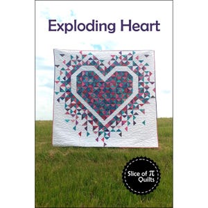 May include: A quilt pattern called "Exploding Heart" featuring a large pink heart with a white outline surrounded by smaller triangles in shades of pink, blue, and teal. The quilt is displayed on a grassy field with a blue sky in the background. The text "Slice of Pi Quilts" is visible in a circle at the bottom of the image.
