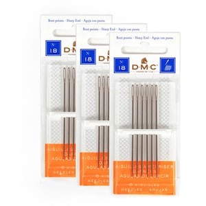 May include: Three packages of DMC brand sewing needles. Each package has a white and orange label with the text "AIGUILLIS", "AGUJAS", and "NEEDLES". The packages are labeled "N 18" and "Sharp End".