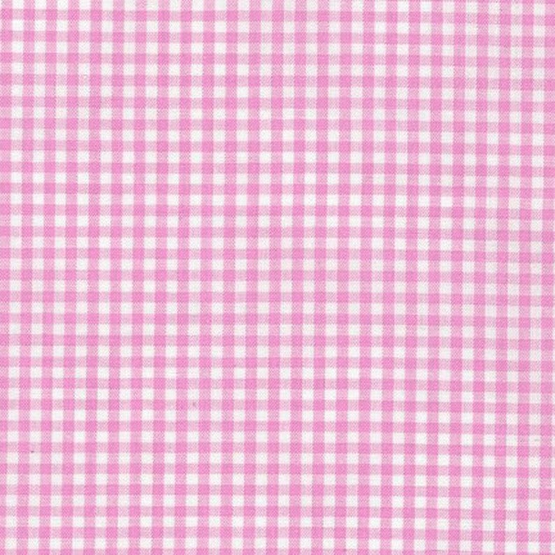 May include: A textile fabric featuring a repeating gingham pattern composed of small, uniform squares in alternating shades of light pink and white. The material displays a consistent, woven grid texture throughout the entire surface area.