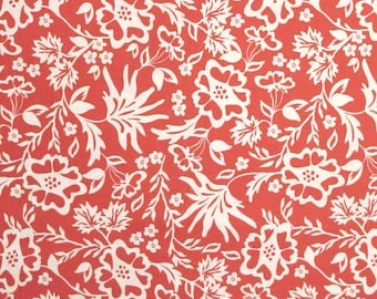 May include: A red fabric with a white floral pattern. The pattern features stylized flowers and leaves.