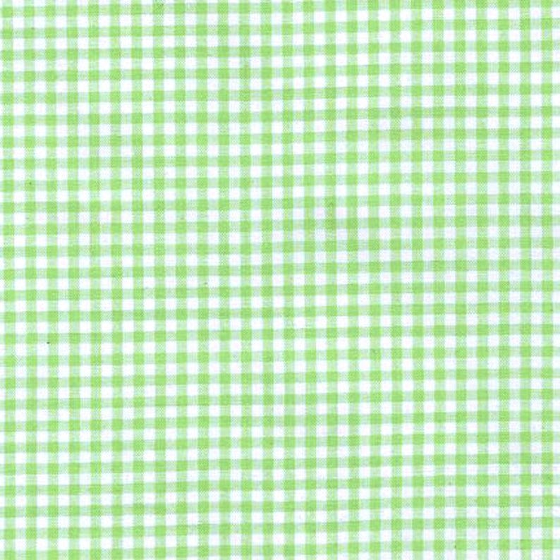 May include: A fabric featuring a classic gingham pattern with a repeating grid of small, light green squares set against a crisp white background. The textile displays a consistent, uniform check design across the entire visible surface area.