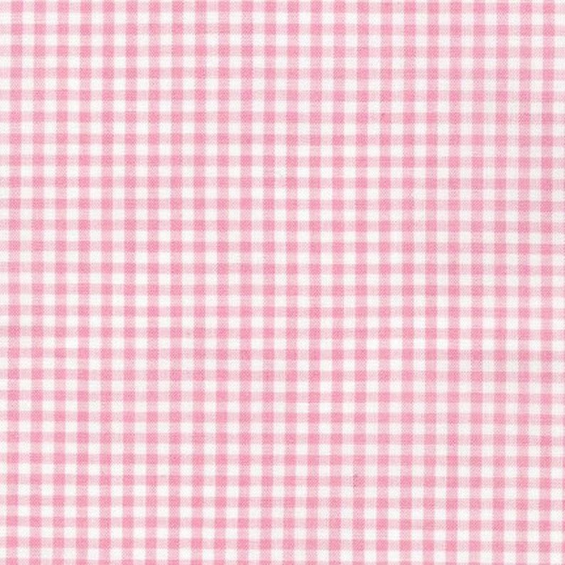 May include: A fabric featuring a classic gingham pattern with a repeating grid of small, light pink squares alternating with white squares. The textile displays a consistent, woven texture throughout the entire surface of the material.