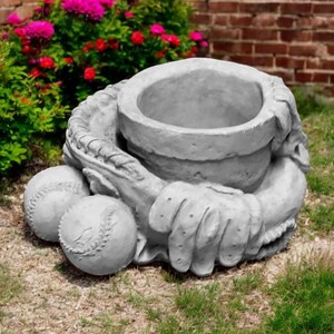 May include: A gray concrete planter shaped like a baseball glove catching a baseball. The planter has a round opening for planting flowers or other plants.