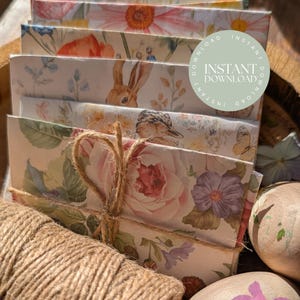 May include: A bundle of floral-patterned paper envelopes tied with twine. The envelopes display diverse designs, including flowers, a rabbit, and a bird. The text "INSTANT DOWNLOAD" is on a circular sticker. A spool of twine and painted Easter eggs are in the foreground.