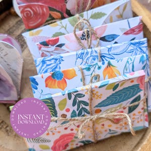 May include: A collection of floral-patterned envelopes bound with twine. The envelopes display diverse floral designs in pink, orange, blue, and green hues. A purple circle with the text "INSTANT DOWNLOAD" is also visible.