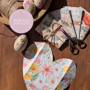 May include: An assortment of craft items with a floral theme, including decorated eggs, patterned envelopes, a heart-shaped cutout, and scissors. The image includes a spool of twine and a circular graphic with the words "Instant Download". The colour palette features soft pastels and natural tones.