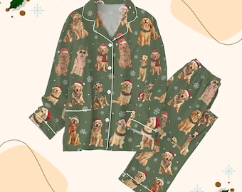 May include: Green pajama set featuring a repeating pattern of Golden Retrievers wearing Santa hats and scarves. The long-sleeved top has white trim and buttons. The matching pants also have the dog pattern. A festive holiday theme.