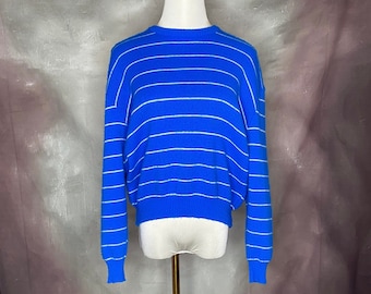 May include: A blue and white striped sweater with long sleeves.