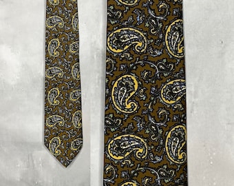 May include: A brown paisley patterned tie with yellow, blue, and black accents.