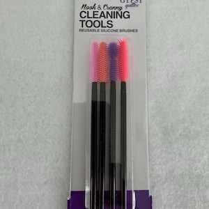 May include: A pack of four reusable silicone cleaning brushes, labeled "Nook & Cranny Cleaning Tools" and "The Gypsy Quilter". The brushes are pink, purple, and black.
