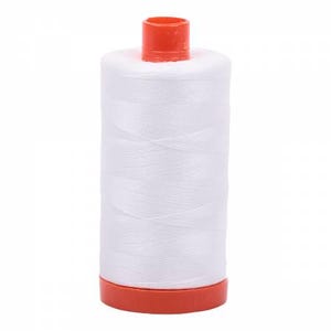 May include: A white spool of thread with an orange plastic bobbin.