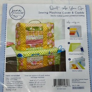 May include: A sewing machine cover and caddy pattern with a floral design. The pattern is printed on batting and includes instructions for sewing by number. The pattern is available in three sizes: small, medium, and large. The pattern also includes instructions for making a caddy. The pattern is from June Tailor.