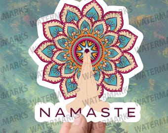 May include: A sticker with a colorful mandala design and the word "NAMASTE" in a white banner. The mandala is in shades of pink, blue, yellow, and orange. The sticker is on a white background.