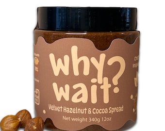 May include: A jar of Velvet Hazelnut & Cocoa Spread with the text "why wait?" in a light brown font. The jar is brown with a black lid. The net weight is 340g. Three hazelnuts are in front of the jar.
