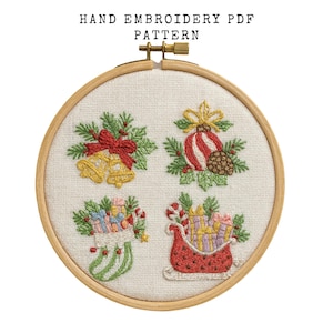 May include: Hand embroidery PDF pattern featuring four Christmas-themed designs: golden bells with a red bow, a striped ornament with a pinecone, a stocking with gifts, and a sleigh filled with presents. The text "HAND EMBROIDERY PDF PATTERN" is at the top.