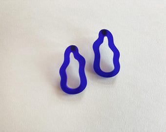 May include: A pair of blue abstract shaped earrings. The earrings are made of a smooth, opaque material and have a slightly irregular shape.