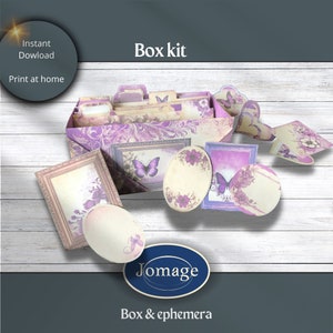 May include: A purple and cream box kit with butterfly and floral designs. The kit includes a box, frames, tags, and other ephemera. The text "Jomage Box & ephemera" is printed on the bottom of the image.