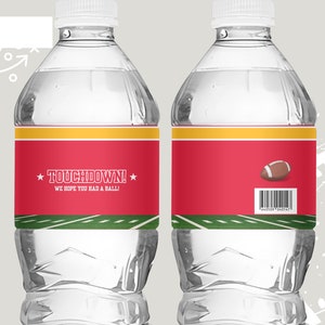 May include: Two clear plastic water bottles with red, yellow and green labels. The labels feature a football and the text "TOUCHDOWN! WE HOPE YOU HAD A BALL!"