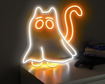 May include: White neon light shaped like a ghost with a tail. The ghost has orange eyes and a white outline. The light is on a white surface.