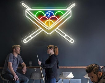May include: A neon sign depicting a pool table with crossed cues and a rack of billiard balls. The balls are numbered 1 and 2, and are colored red, yellow, green, and blue.