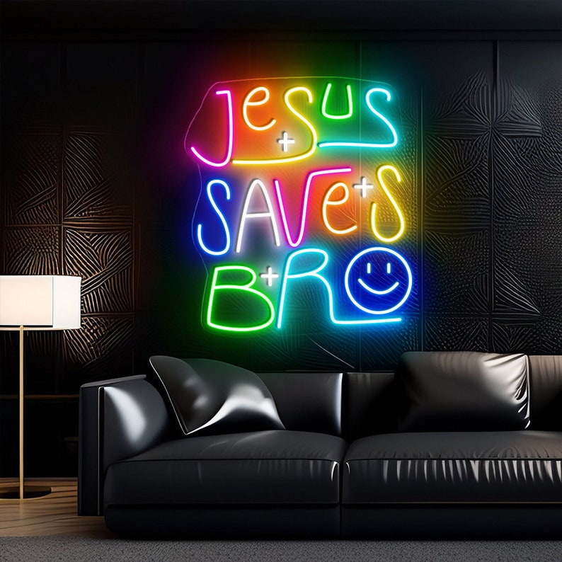 May include: A neon sign with the words "Jesus Saves Bro" in rainbow colors. The sign has a smiley face at the end of the word "Bro".