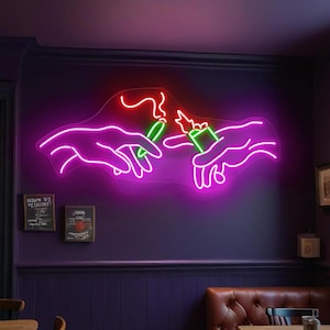 May include: Neon sign depicting two hands, one holding a lighter and the other holding a joint, with a flame above the lighter. The sign is pink and green.