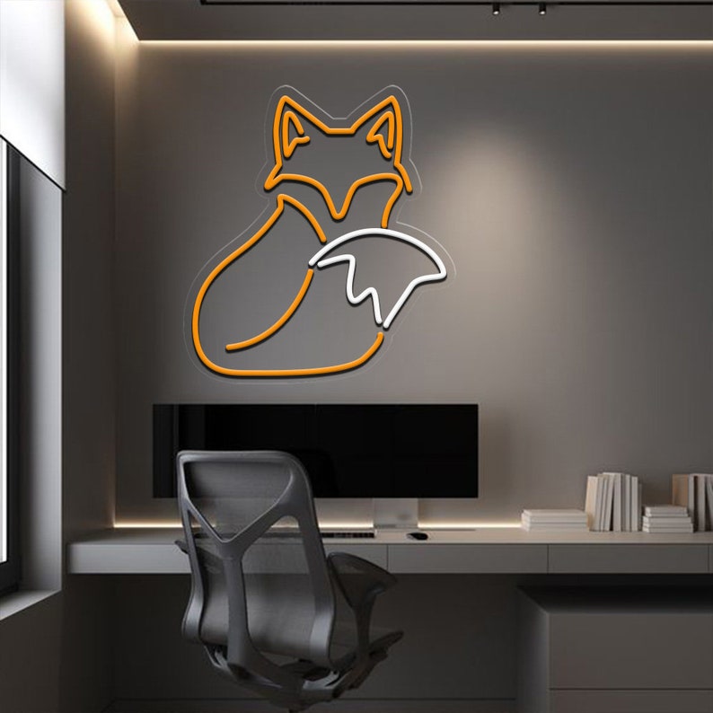 May include: A neon sign in the shape of a fox with an orange outline and a white interior. The sign is mounted on a gray wall in a home office setting.