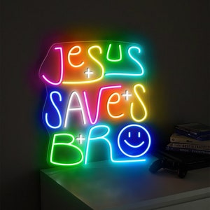May include: Neon sign with the text "Jesus + Saves + Bro" in rainbow colors with a smiley face at the end.