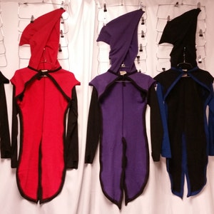 May include: Five hooded cloaks in different colors, including black, red, purple, blue, and green. Each cloak has a pointed hood and a long, flowing design. The cloaks are all made of a soft, comfortable fabric.