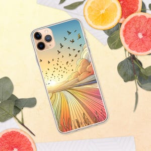 Może przedstawiać: Przezroczyste etui na telefon z kolorowym wzorem zachodu słońca i pola. Etui przedstawia stado ptaków przelatujących nad polem trawy z zachodem słońca w tle. Etui ma przezroczyste plecy i czarną ramkę.