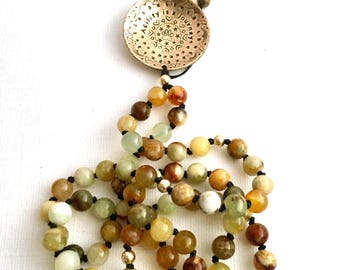 Hand Stamped Brass Agility Pendant on Hand Knotted Flower Jade Necklace