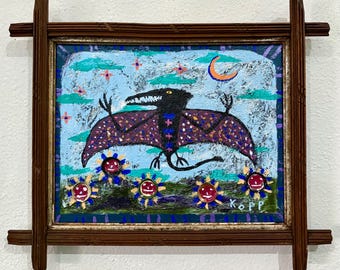 May include: A framed painting features a black winged creature with a long tail against a light blue sky with stars and a crescent moon. Below, four circular sun-like faces with red centers sit on a green field. The artist signature KOPP is visible.