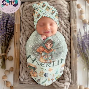 May include: A baby swaddled in a green and white swaddle with a cartoon character and the name "Merlin" printed on it. The baby is wearing a green and white hat with the name "Merlin" printed on it.