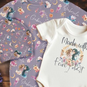 May include: A baby onesie with the text "Made with Fairy Dust" and a floral design. A matching set of purple leggings with a floral design and the name "Gabriela" repeated throughout.