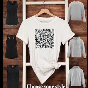 May include: A white t-shirt with a black QR code printed on the front. Choose your style from a variety of clothing options including a tank top, a hoodie, and a sweatshirt.