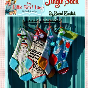 May include: Four colorful knitted Christmas stockings with pom-poms hanging on a metal rack. The stockings are decorated with snowman, snowflake, and lightbulb designs. The text "Jingle Sock" and "By Rachel Knoblich" is visible at the top of the image.