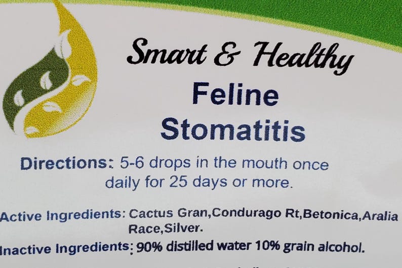 May include: A white label with green and yellow leaf designs. The text "Smart & Healthy Feline Stomatitis" is printed in black. Directions for use are listed: "5-6 drops in the mouth once daily for 25 days or more." The active ingredients are listed: "Cactus Gran, Condurago Rt, Betonica, Aralia Race, Silver." The inactive ingredients are listed: "90% distilled water 10% grain alcohol."