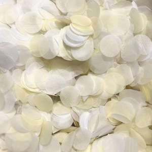 May include: A large pile of white and cream paper confetti circles. The confetti is made of thin, delicate paper and is perfect for adding a touch of elegance to any celebration.