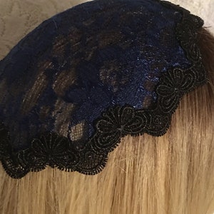 May include: A navy blue lace head covering with a black lace trim.