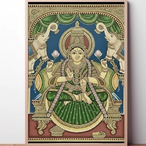 May include: A framed, colorful painting of a seated deity, adorned with jewelry and a crown. The artwork features a green and gold color scheme, with elephants and lotus flowers. The background is blue, and the frame is a light pink.