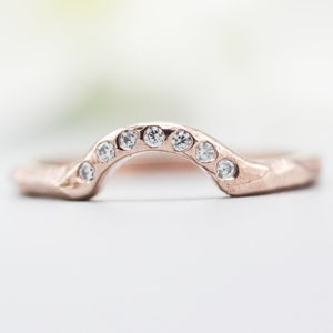 14k rose gold with geometric design band ring with tiny 7 diamond on the center