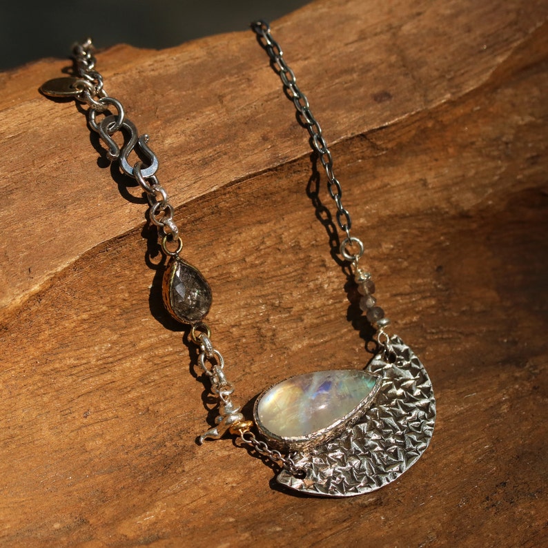 Moonstone pendant necklace in silver bezel setting and silver textured fan with black rutilated quartz on the side and oxidized silver chain