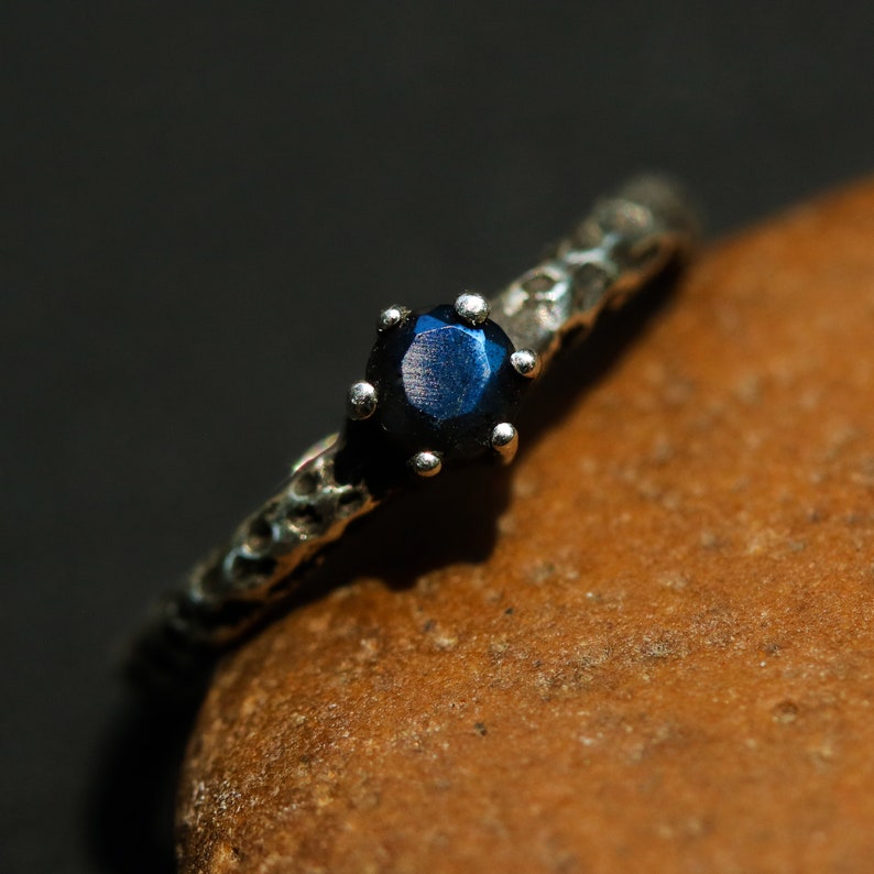 Round faceted labradorite ring in prongs setting with sterling silver oxidized texture band