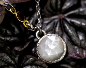 Round faceted White Moonstone pendant necklace in silver bezel setting